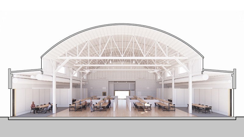 A cross-section rendering of Highland Hall shows conference rooms against the wall, an open center space with student work stations, and more conference rooms agains the other wall. 