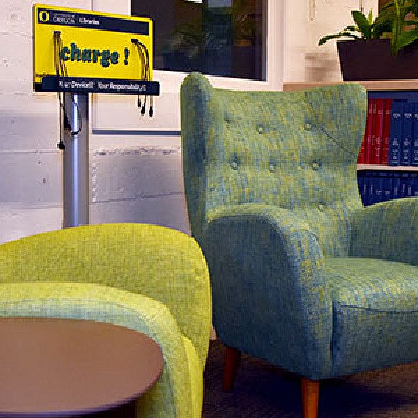 The library has cushioned chairs and charging stations.