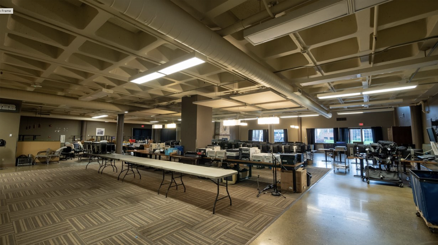 Before photos shows the dining room of the UO Portland Campus Center. The space is dark and filled with tables full of old electronics to remove. 