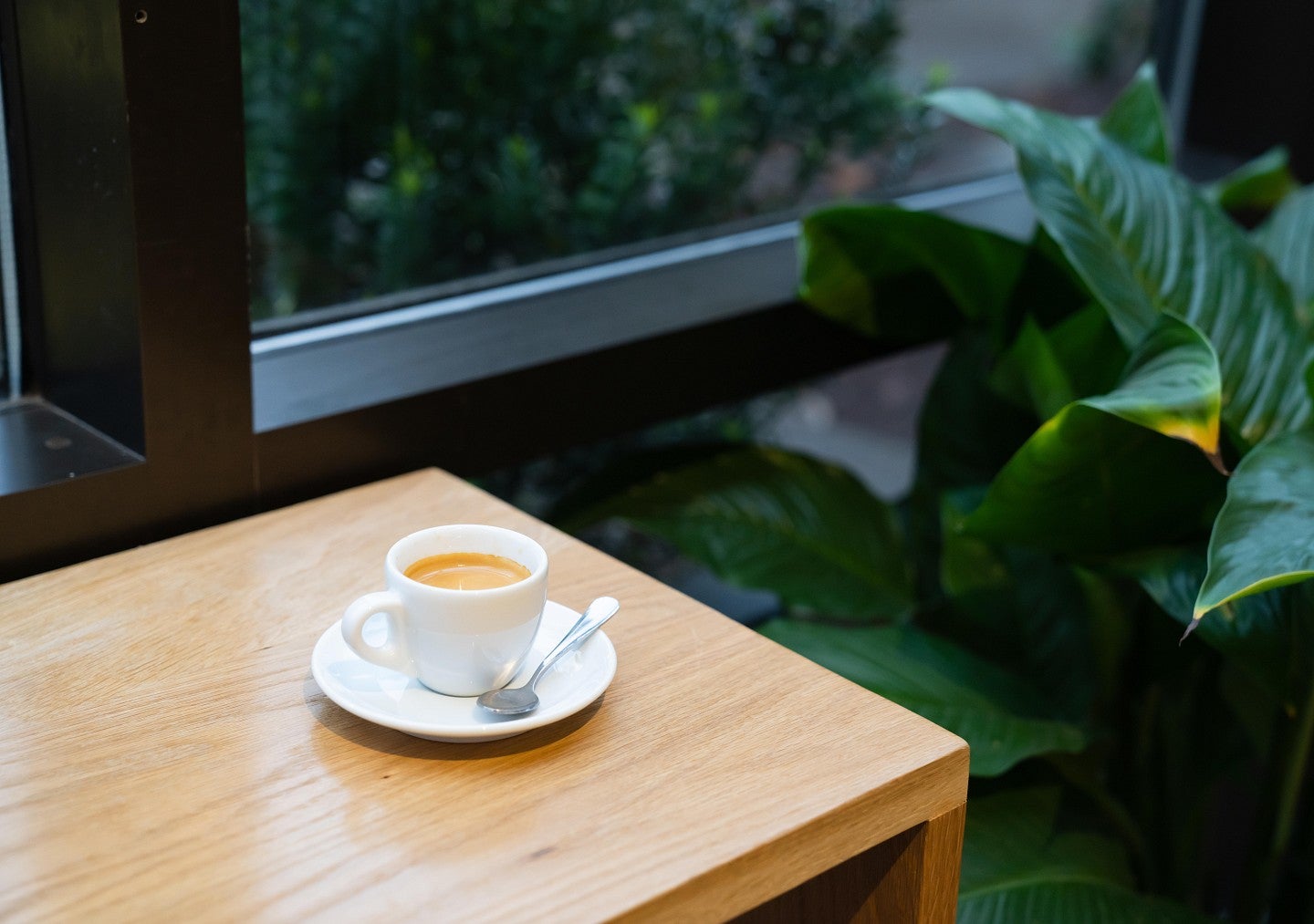 An espresso cup sits on a table