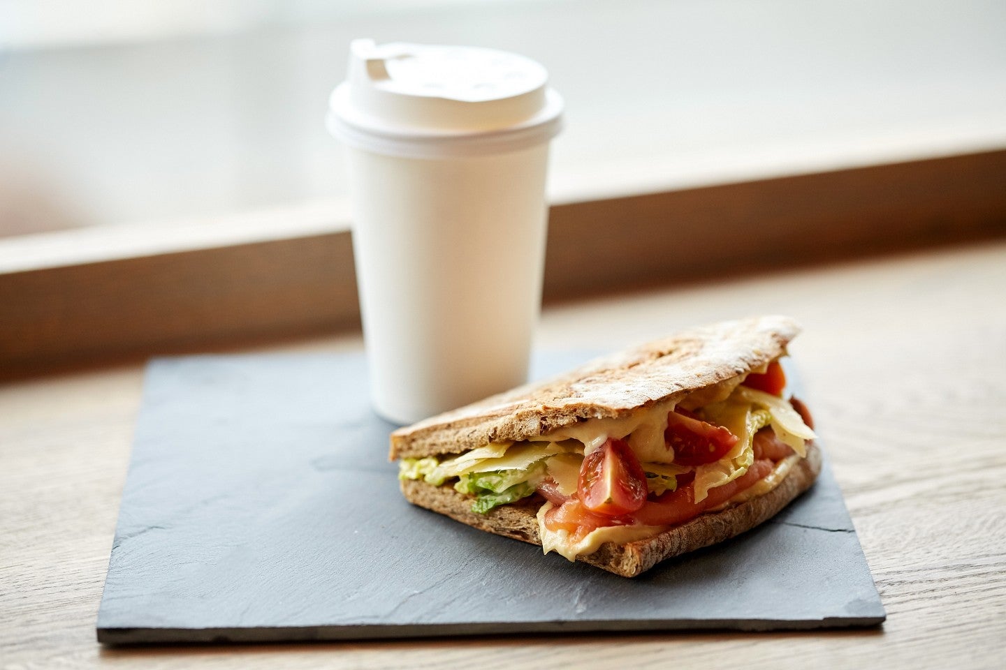 sandwich and coffee with a neutral background