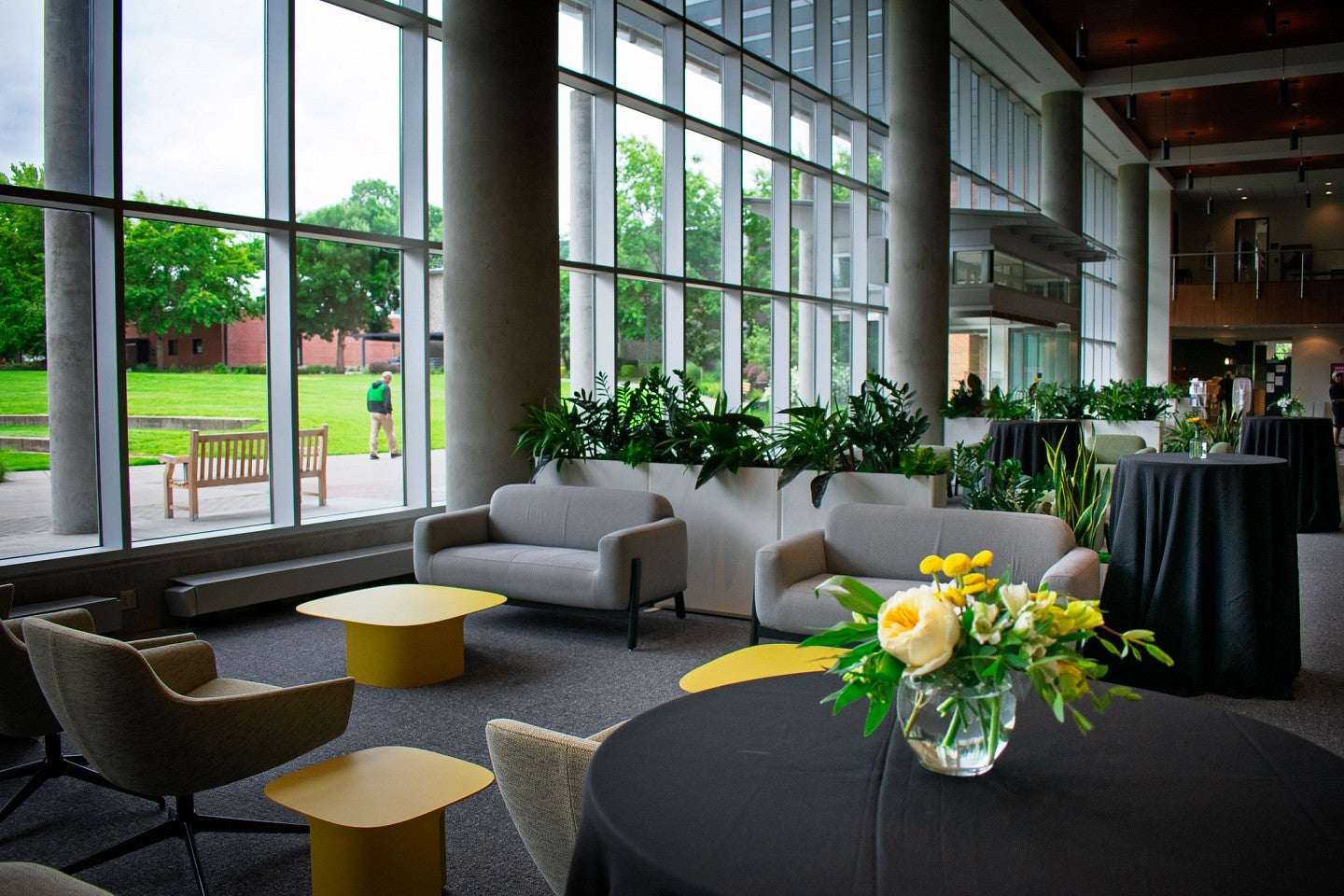 Alumni Atrium with couches and chairs that look out over a green space