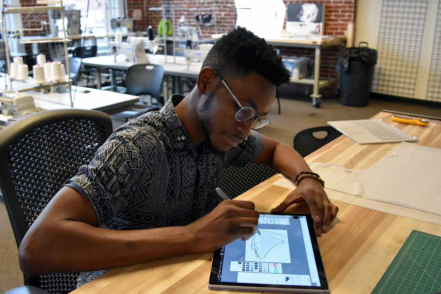 Academic programs A sports product design student sketches a shoe on a tablet