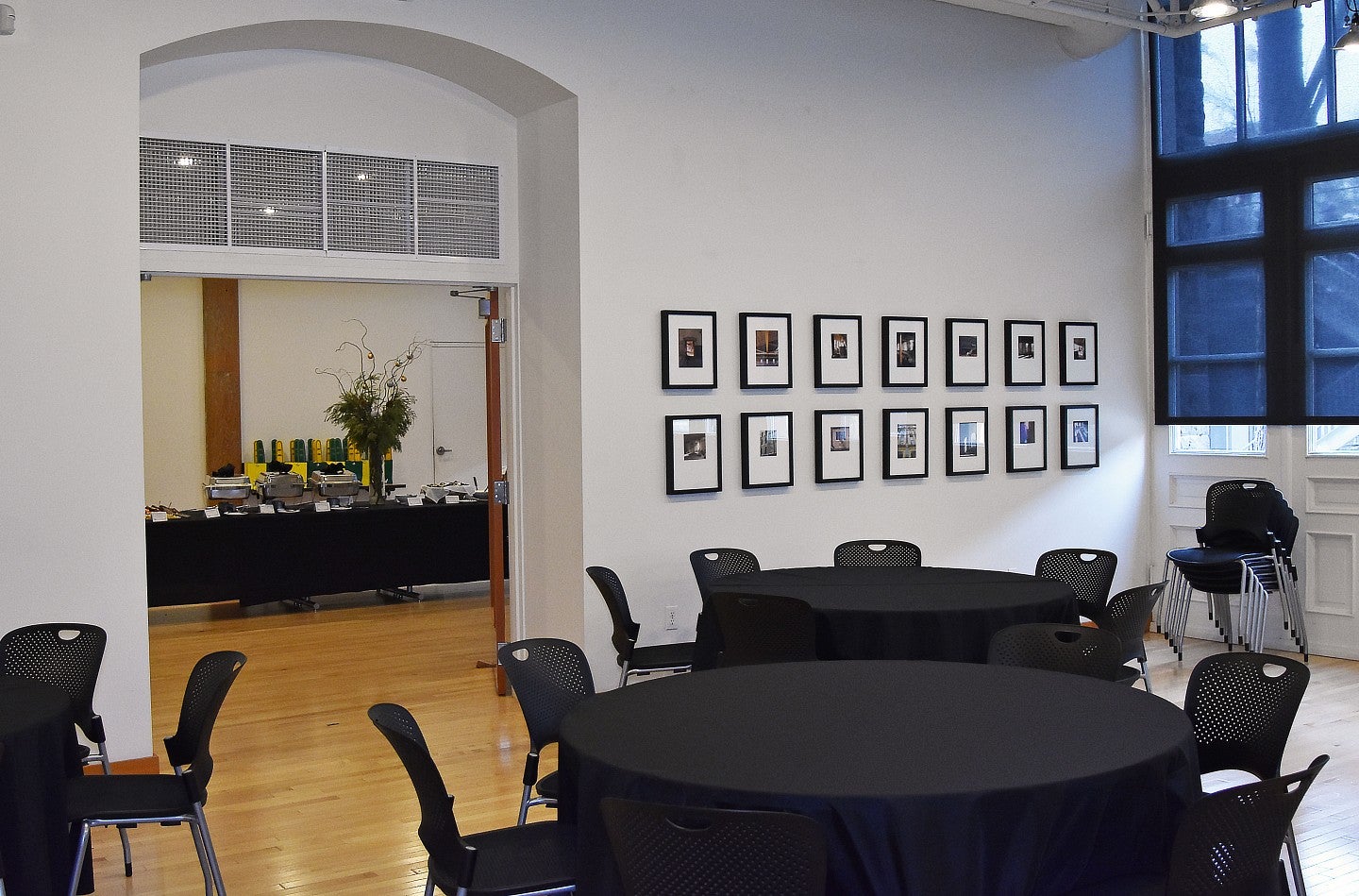 White Box set up with round tables and the extra room set up with a buffet table. 