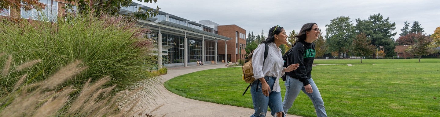 Two UO students walk on campus