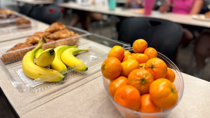 bananas, oranges, and croissants in bowls