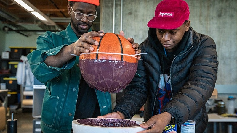 Sports Product Management students make mold of basketball