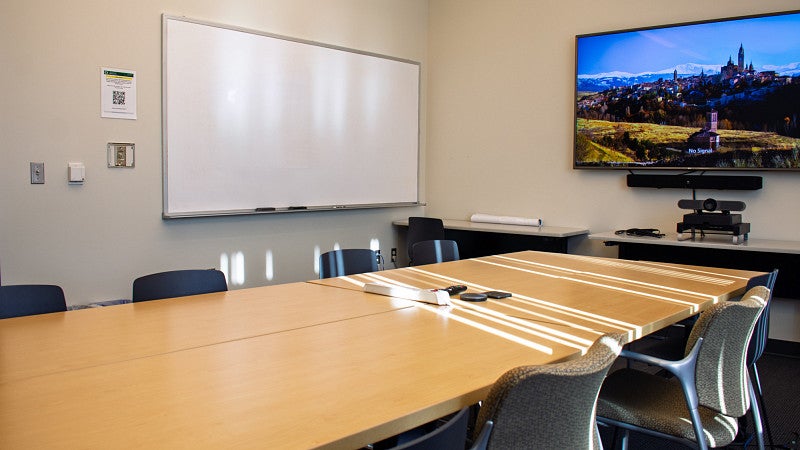 Conference room with white board and screen on the wall