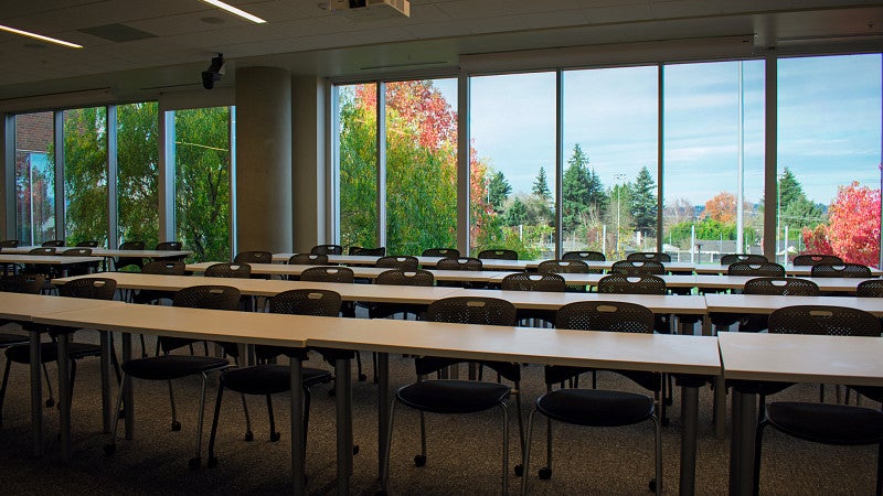 The classroom has long rows of tables and panoramic views to the north. 