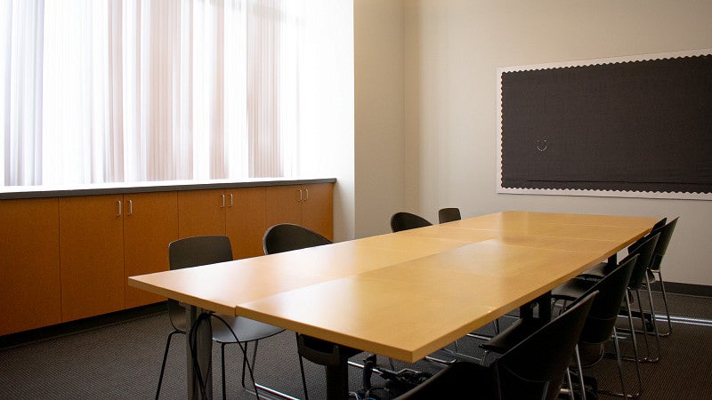 The room has a large window that overlook the campus green.