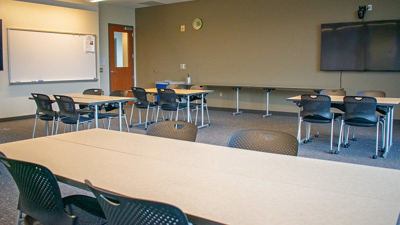 There are multiple display screens and a long table for materials and catering. 