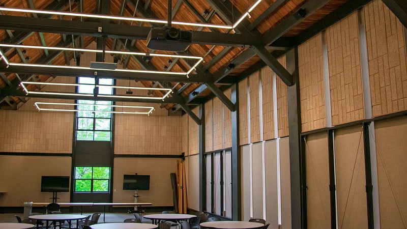 The side walls include metal frames that roll out to display large posters. 