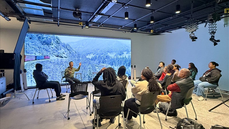 Students in front of the LED wall in the production studio