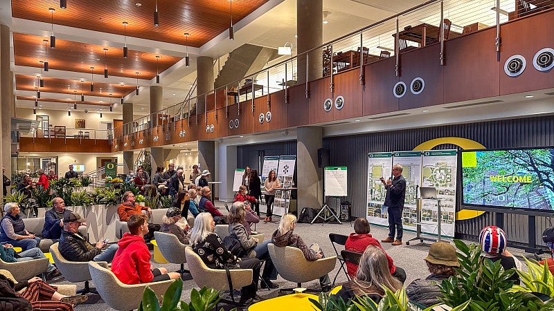 People gathered on couches in the Alumni Atrium for an event. 