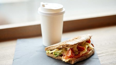 sandwich and coffee with a neutral background