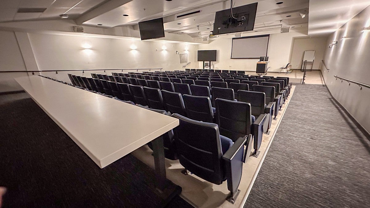 The Innovation Auditorium looking towards the stage with rows of theater-style seating.