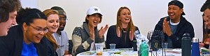 Portland Student Resources Students laugh and clap during a bingo game event.