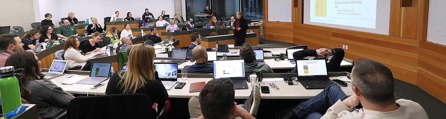 Students listen to a professor during an Oregon Executive MBA class.