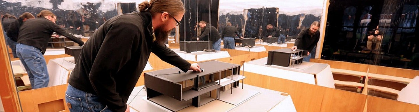 A man works on a building design.
