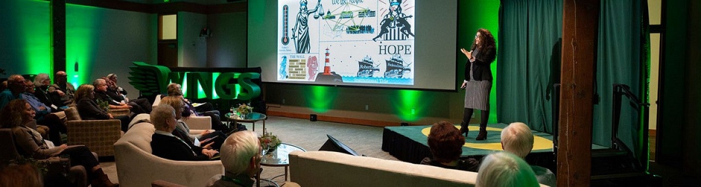 A speaker talks to an audience during the Wings event 2018.