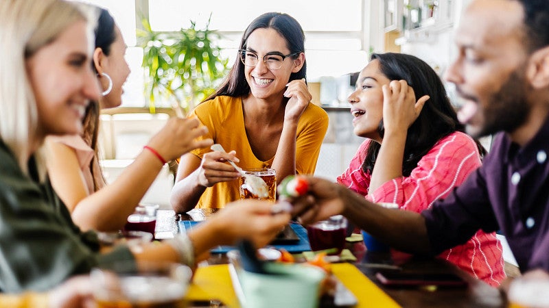 Young adults eating stock image