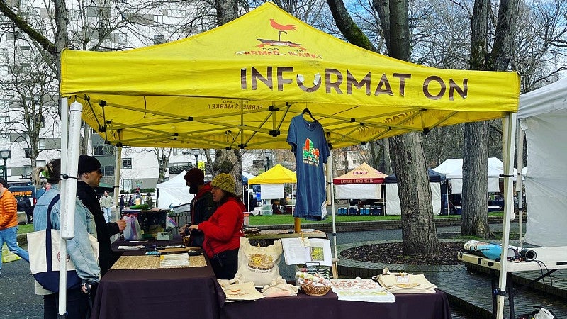 The Yellow Information Tent at the Farmers Market on Portland State University's Campus