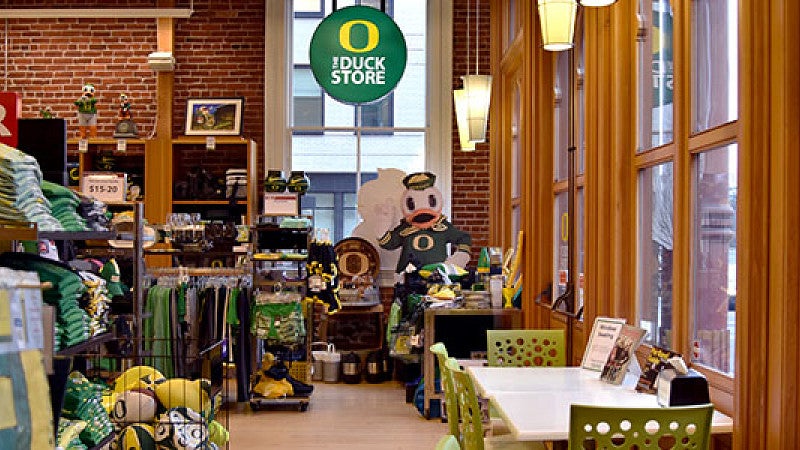 Duck Store 2019 The Duck Store has apparel and souveniers and a seating area by a window.