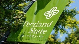 Portland State University's green flag with white letters and logo.